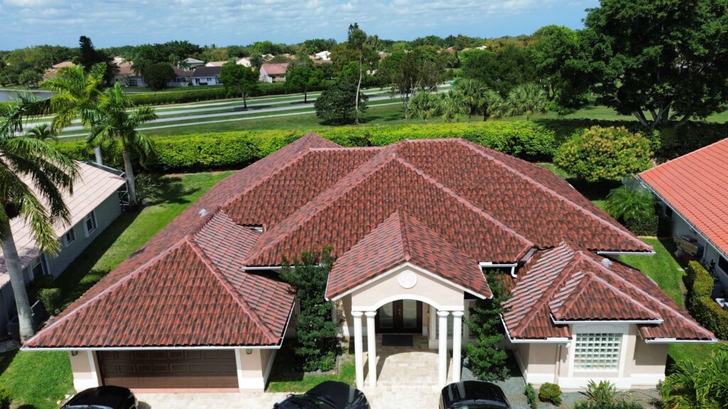 Aerial view of a home with a red tile roof and an arched entryway