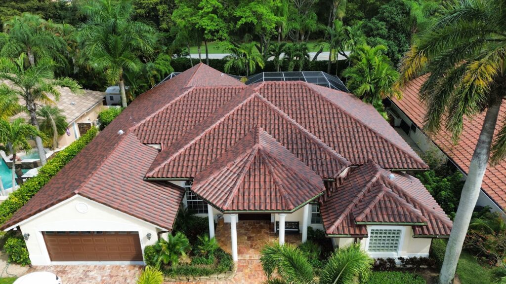 Aerial view of a two-story home with a brown clay tile roof
