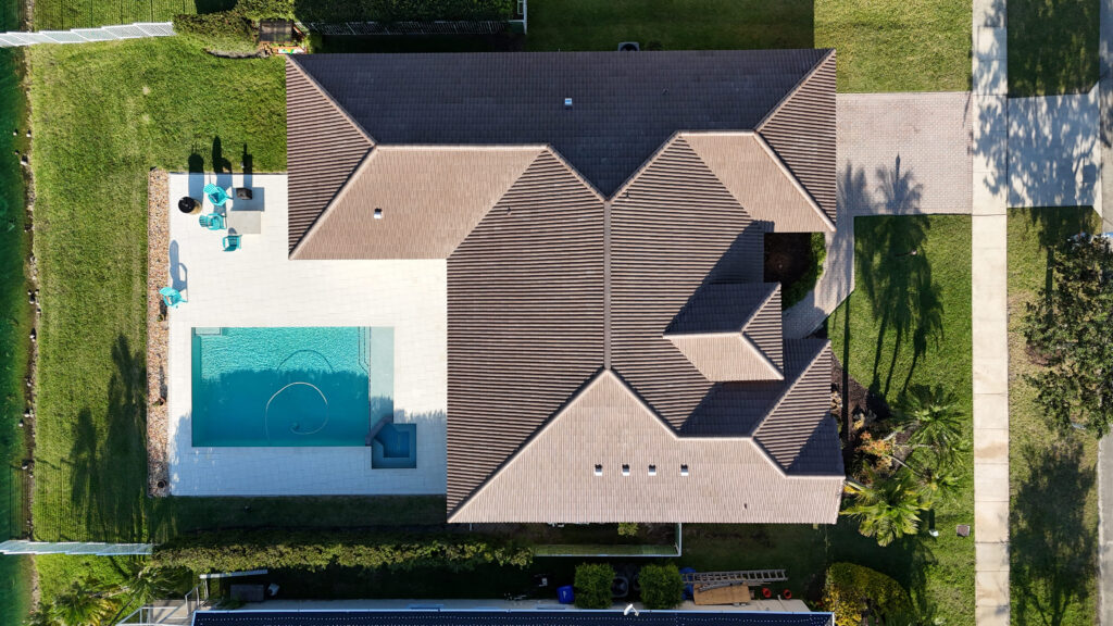 Overhead view of a brown shingle roof on a home with a pool
