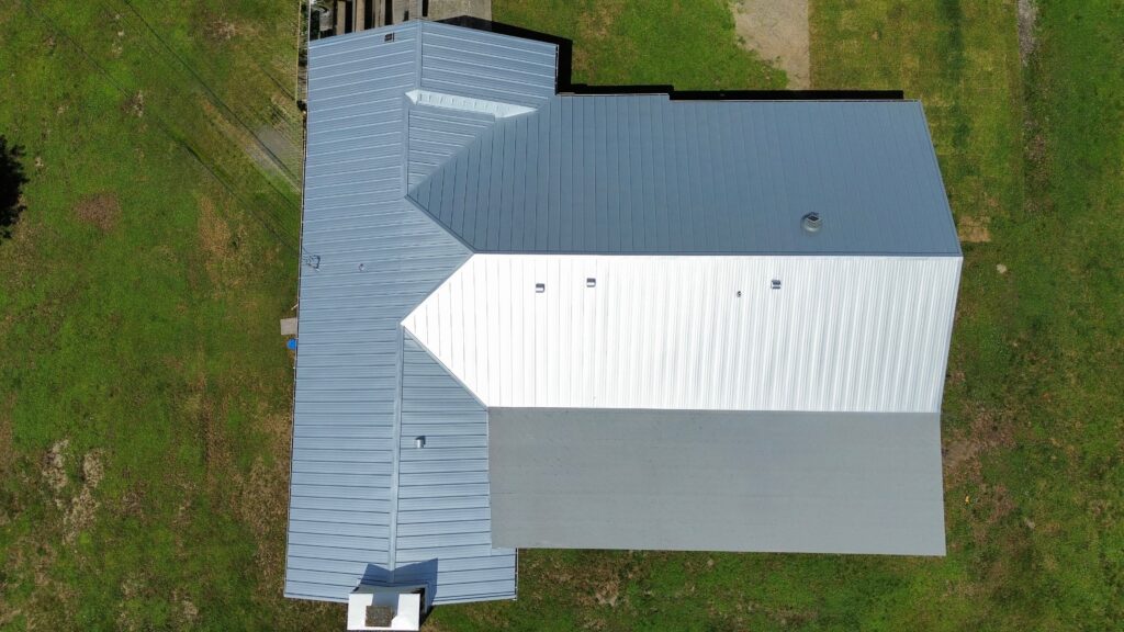 Overhead view of a light gray metal roof on a rectangular building