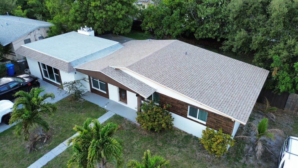 Aerial view of a single-story home with a light gray shingle roof
