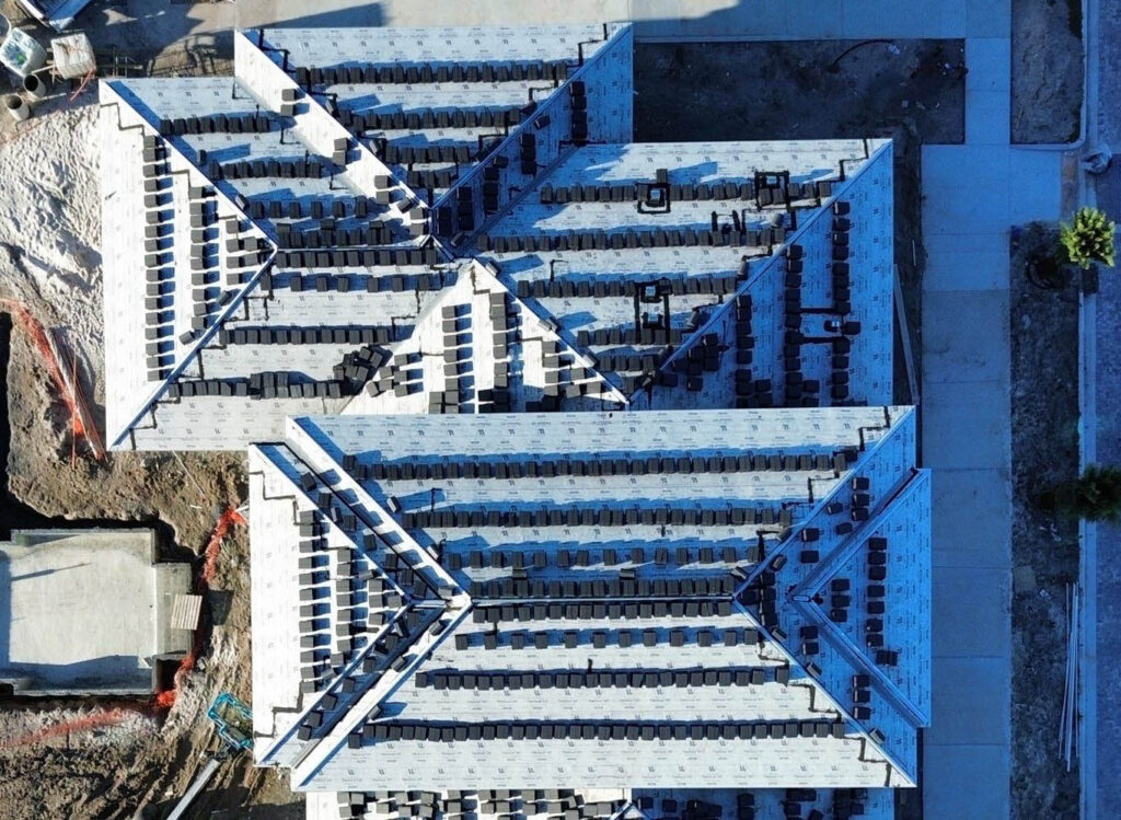 Aerial view of a new roof deck with underlayment during installation