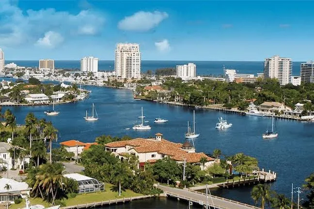 Aerial view of waterfront homes, sailboats and coastal high-rises in Broward County, FL