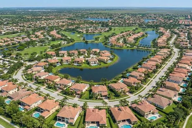 Aerial view of a lakeside residential neighborhood with tile roofs in Coral Springs, FL