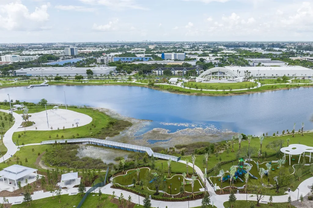 Aerial view of a lake, park trails and commercial buildings in Doral, FL