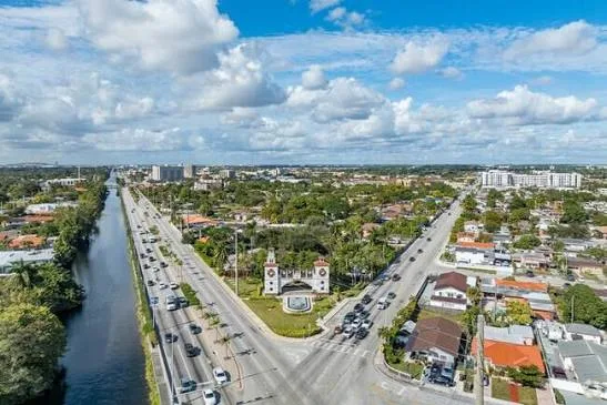 Aerial view of a canal, busy highway and neighborhoods in Hialeah, FL