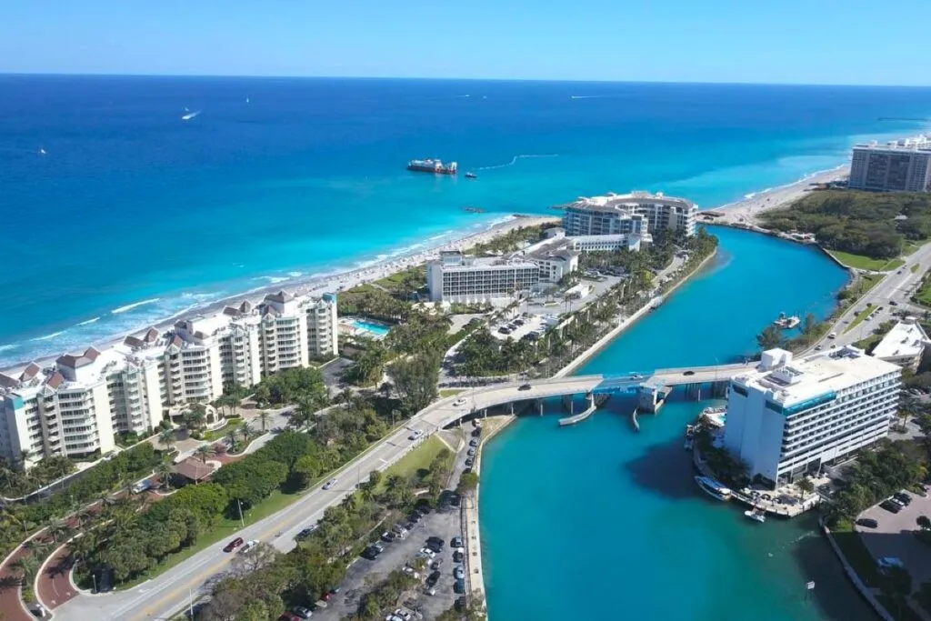Aerial view of an inlet, bridge and oceanfront condominiums in Palm Beach County, FL